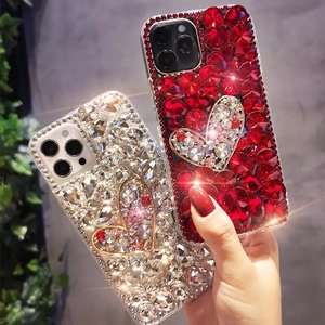 Close-up of sparkling heart-shaped diamond-studded iPhone case with luxury rhinestones