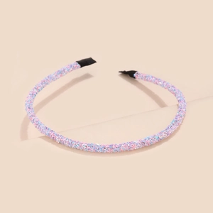 Detail of slim headband with pastel pink blue and purple sequins on beige background