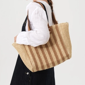 Beige and brown striped woven straw tote bag with shoulder straps for beach vacation