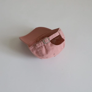 Minimalist pink cotton baseball cap for kids with an adjustable metal buckle on the back