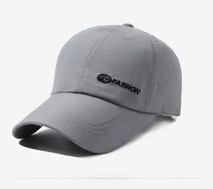 Detailed close-up of dark grey quick-dry baseball cap with laser-cut breathability holes