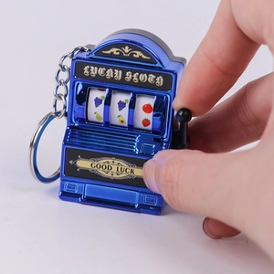 Macro shot of hand operating a blue mini Lucky Sloth slot machine keychain with metal ring
