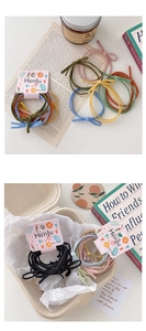 Close-up of assorted colorful elastic hair ties with Henju brand card packaging