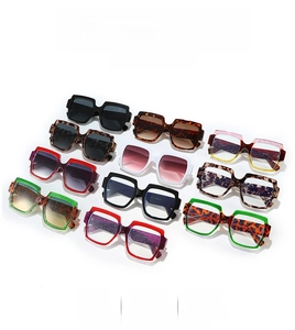 Collection of retro square oversized sunglasses in various colors on a white background