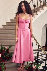 Detail of pink retro slip dress featuring corset-style buttons and elegant bodice