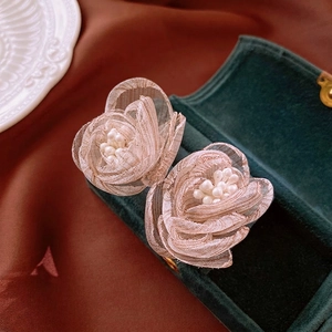 Elegant floral tulle earrings with white faux pearls on vintage dark velvet jewelry box