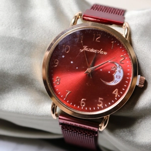 Elegant women's gold watch with red sunburst moon dial and red Milanese mesh band