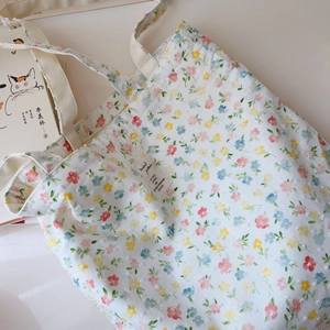 Detailed close-up of floral cotton tote bag with 3D dot texture and soft flower patterns