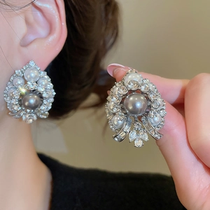 Detail view of vintage water drop earrings with grey pearls and sparkling crystals