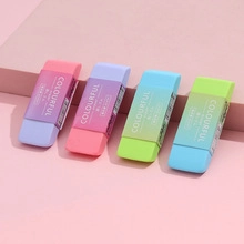 Close-up of four colorful dual-tone erasers with paper sleeves on pink background