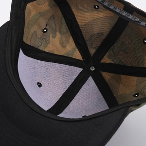 Detailed interior of camouflage baseball cap showing sweatband and top stitching quality