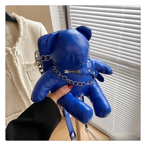 Detail of blue teddy bear PU leather crossbody bag featuring silver chain and metal plate