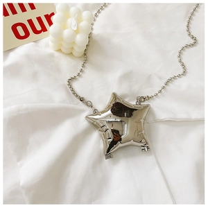 Detailed top view of a silver star-shaped mini bag with a metallic mirror finish on fabric