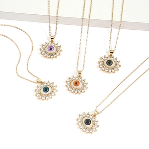 Detailed view of evil eye sunburst pendants with colorful cubic zirconia in five colors