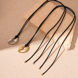 Minimalist irregular geometric pendant necklace in gold and silver on textured stones