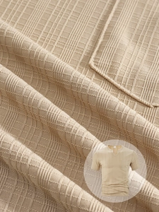 Close-up detail of khaki textured knit fabric on a men's V-neck short sleeve shirt