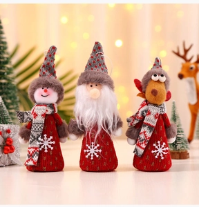 Close-up of knitted Christmas plush ornaments featuring Santa, Snowman and Reindeer