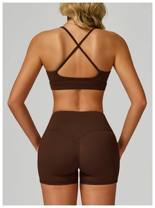 Detail view of the criss-cross back design on a brown premium yoga sports bra