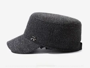 Close-up of the dark grey wool blend military cap featuring a silver metal R logo