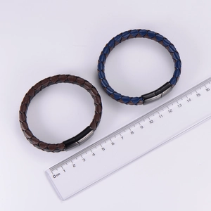 Close-up of woven leather bracelets with black magnetic clasps and size measurement