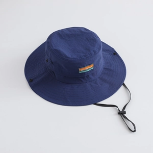 Detail of dark blue sun hat with adjustable wind rope and Better Self decorative patch