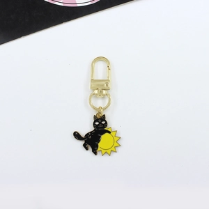 Gothic black cat hugging yellow sun enamel keychain with golden metal clasp and swivel ring