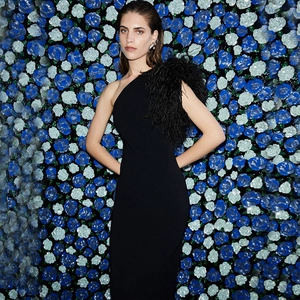 Detail shot of elegant black one-shoulder evening dress with luxury feather decoration