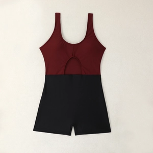 Flat lay of a cutout one-piece swimsuit in burgundy and black with boyleg shorts