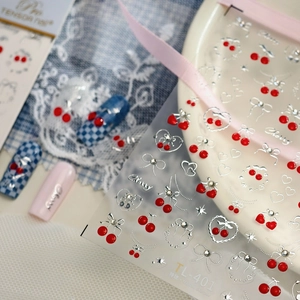 3D cherry nail art stickers with silver bows, hearts and stars on checkered base