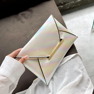 Macro shot of white holographic leather envelope clutch bag with gold metallic V closure detail