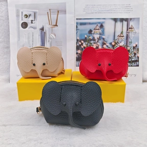 Elephant-shaped leather coin purses in beige, red, and black with pebbled texture