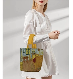 Detail of artistic handbag featuring Van Gogh bedroom painting and yellow handles