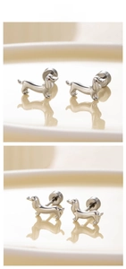 Macro detail of silver dachshund stud earrings showing polished finish and screw backs