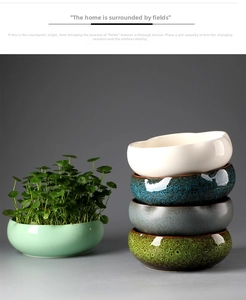 Detail of stacked ceramic hydroponic pots with wave rim and colorful glaze finish