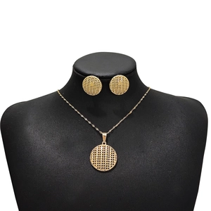 Detail of gold geometric hollow round pendant necklace and stud earrings set on a mannequin
