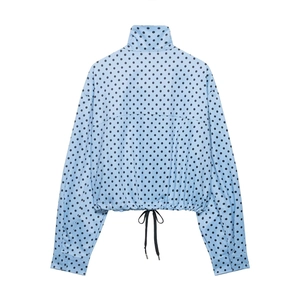 Back view of light blue polka dot jacket showing drawstring hem and button cuff details