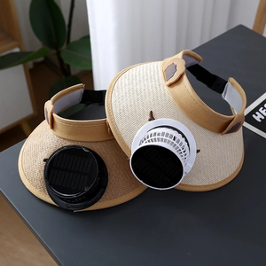 Close-up of beige straw sun hat featuring solar fan details and woven texture for kids