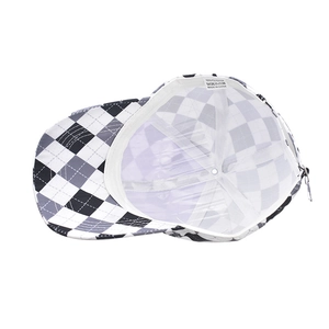 Detail of check baseball cap interior showing 100% polyester fabric and inner stitching