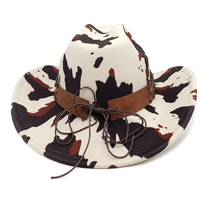 Detail of western cow print wool felt cowboy hat with brown leather belt and buckle