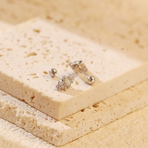 Macro detail of S925 silver opal stud earrings with screw back on a stone base