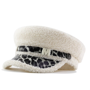 Détail d'une casquette en laine sherpa avec visière léopard et lettre M en métal
