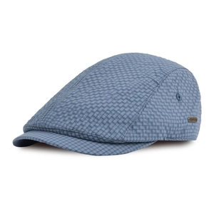 Detail of blue and white seersucker flat cap with a small bronze metal side logo plate