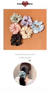 Detail view of large pleated hair scrunchies in six colors with glossy fabric texture