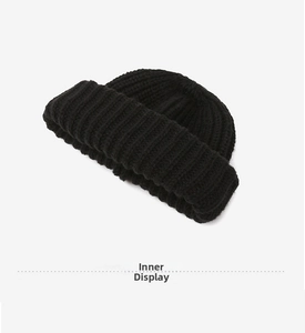 Detailed view of the soft black knit texture and inner lining of this warm beanie hat