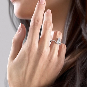 Close-up of model wearing pear-shaped zircon ring with micro-pave setting on hand