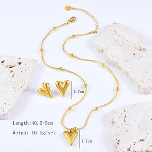 Detail view of gold heart necklace and earring set with size and weight dimensions
