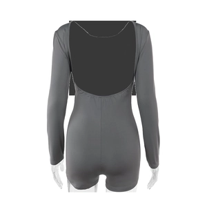 Detail view of the deep grey long sleeve bodysuit featuring an open back design