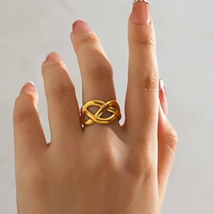 Irregular crossover 18K gold plated stainless steel wrap ring worn on a woman's finger