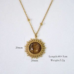 Detailed macro of a 20mm sun pendant with tiger eye stone and dimensions information