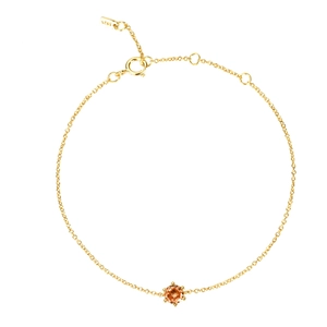 Close-up of a gold S925 silver chain bracelet featuring a round orange zircon gemstone